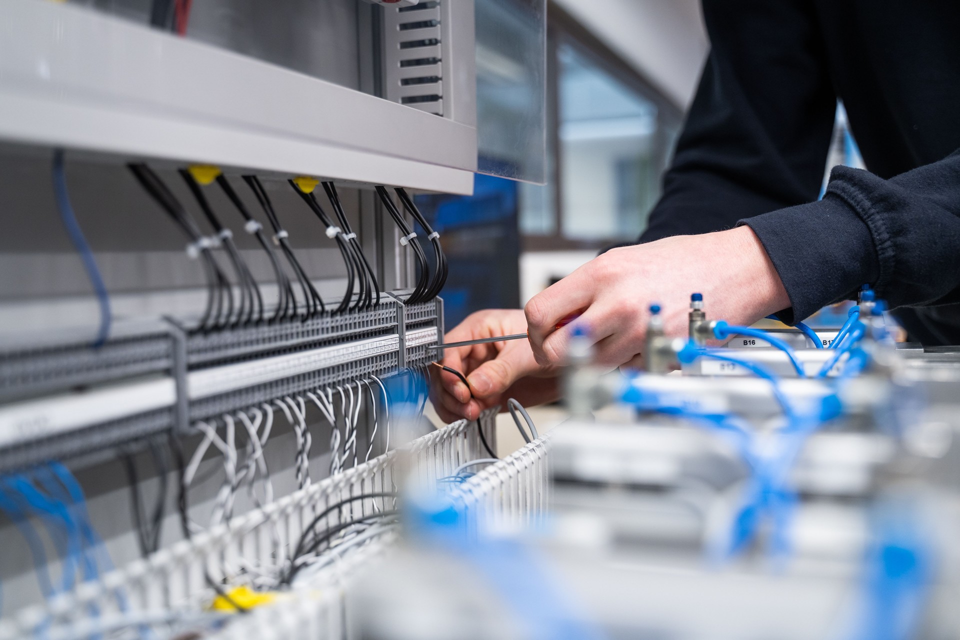 Detail of electrician using equipment in shop